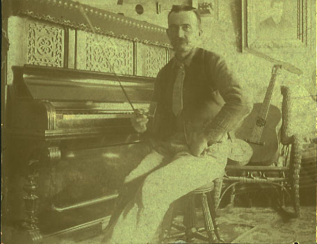 Emory Gifford and violin, mandolin, and guitars he made (c.1905)